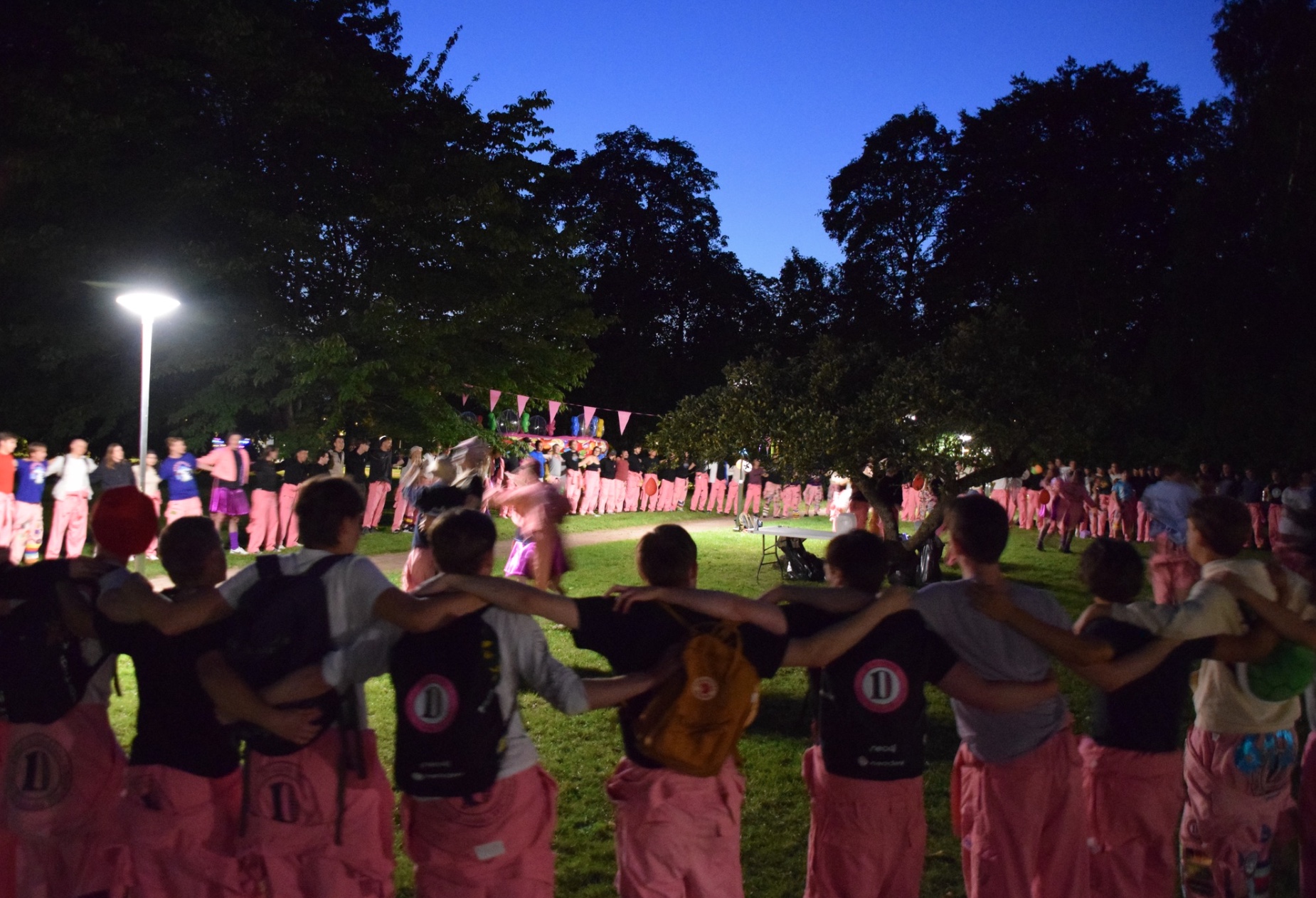 Students during the nollning standing in a circle and singing